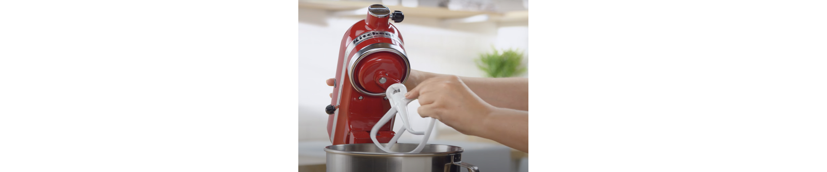 Maker attaching flat beater accessory to red KitchenAid® stand mixer 
