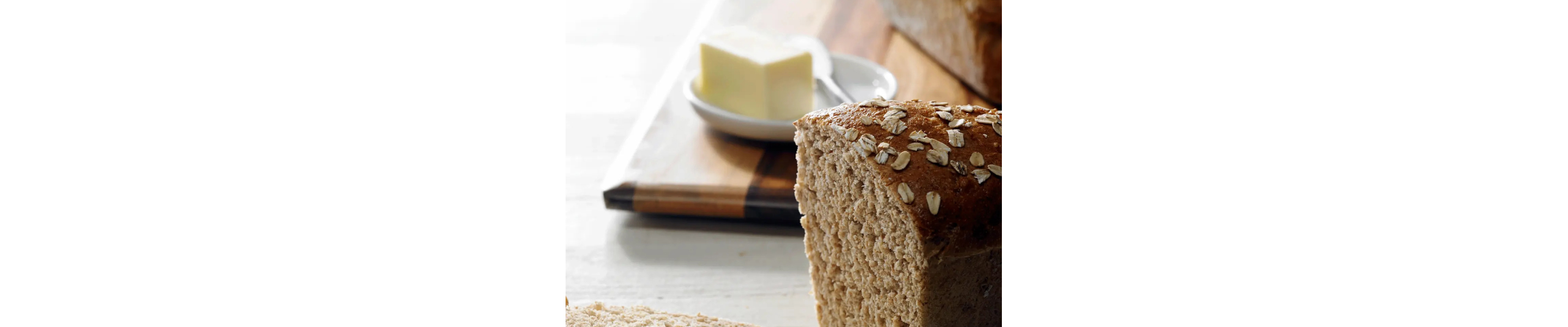 Honey wheat bread next to a stick of butter