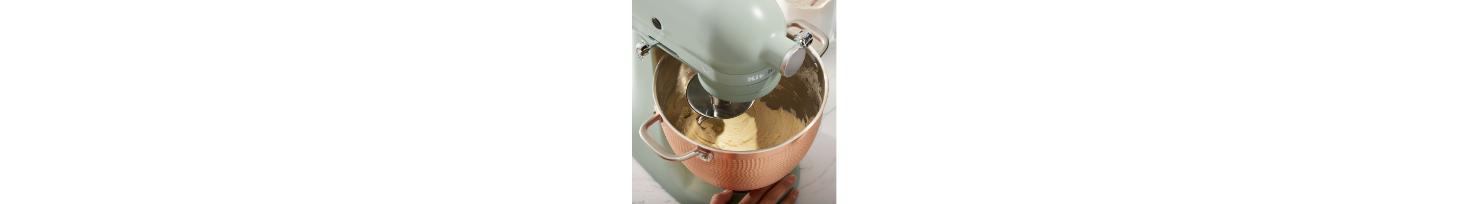 Ingredients being mixed in bowl of  KitchenAid® stand mixer