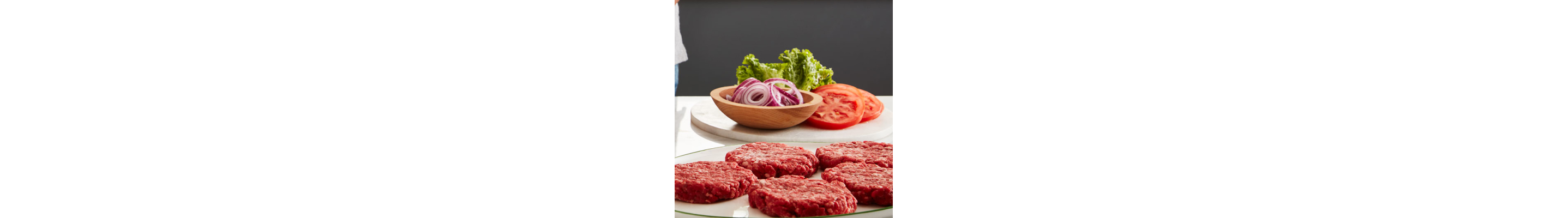 Ground meat patties and tomato, lettuce and onion