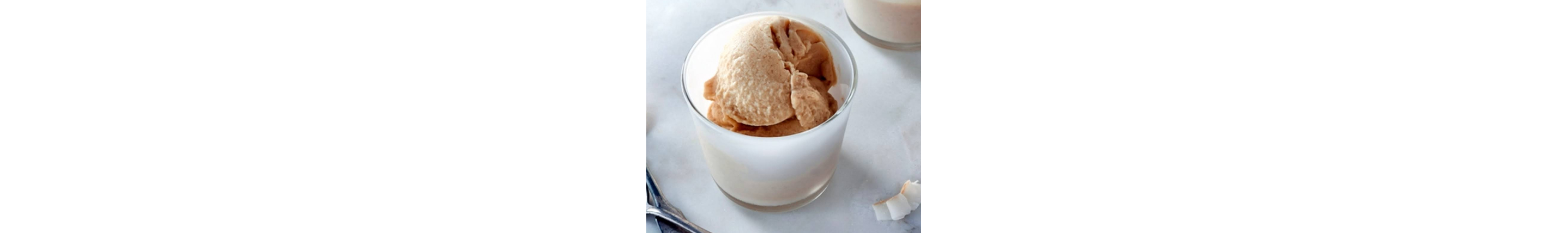 Scoop of Pineapple Coconut Ice Cream in clear glass bowl