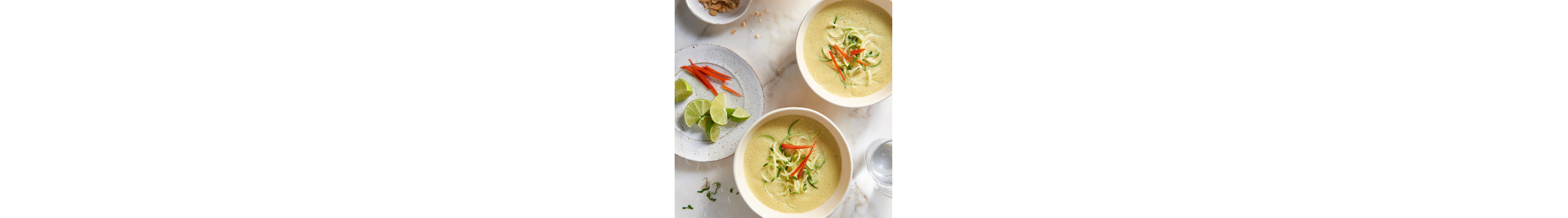 Two bowls of curried coconut soup from Yummly recipe