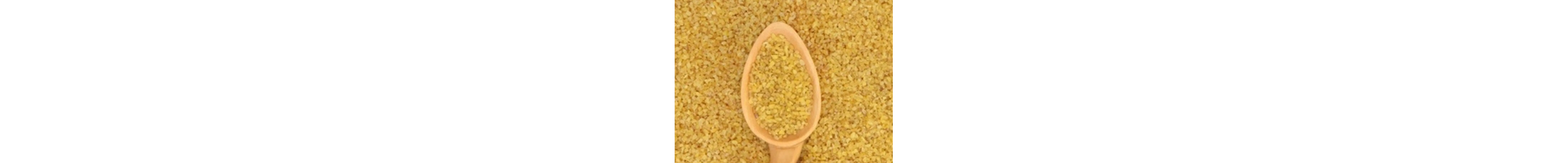A spoon in a mound of bulgur.