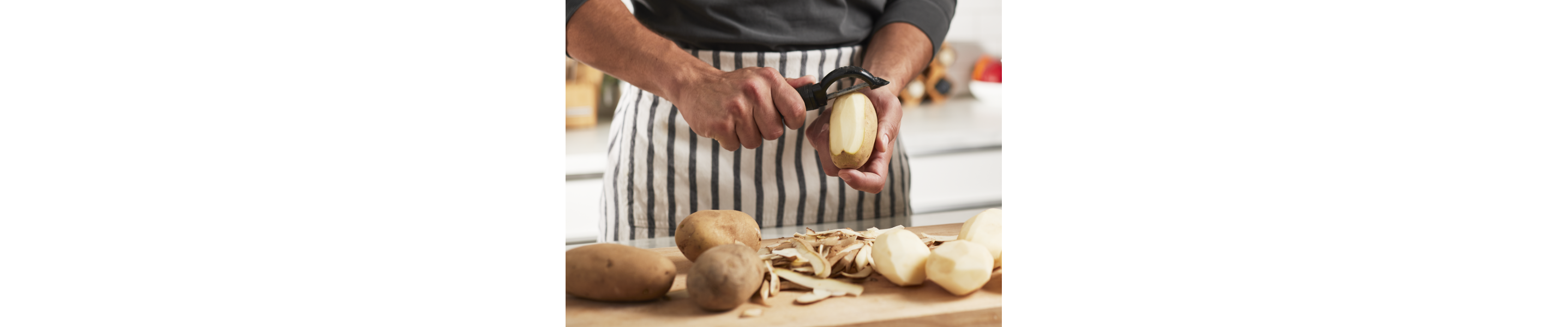 A person peeling potatoes.
