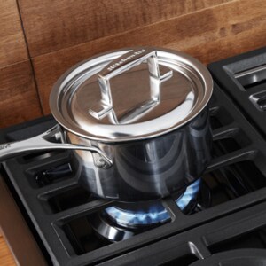 A covered saucepan on a burner