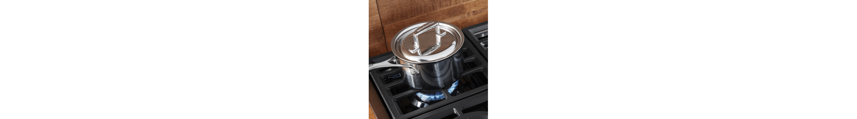 Saucepan with a lid heating on a gas cooktop