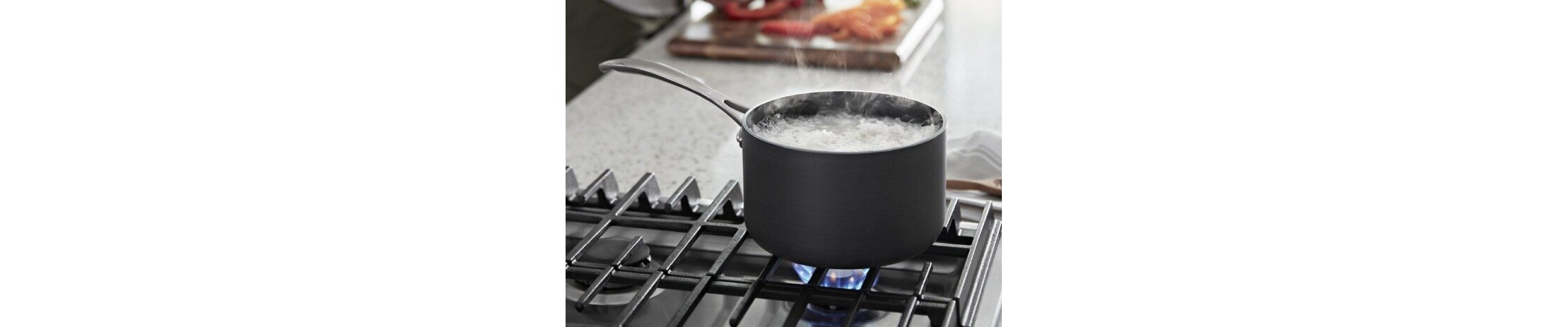 Water boiling in a saucepan on a gas stovetop over a flame