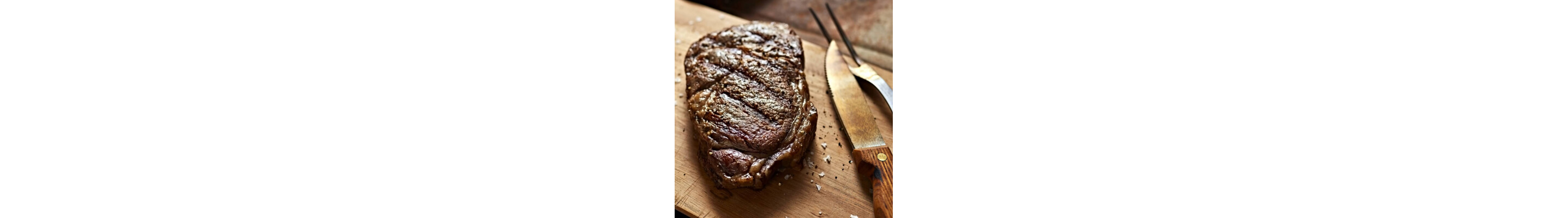 Cooked steak resting on a cutting board