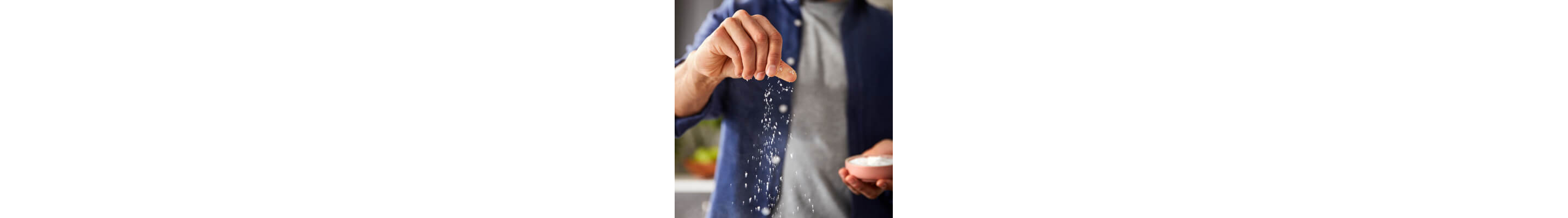 Person sprinkling seasoning