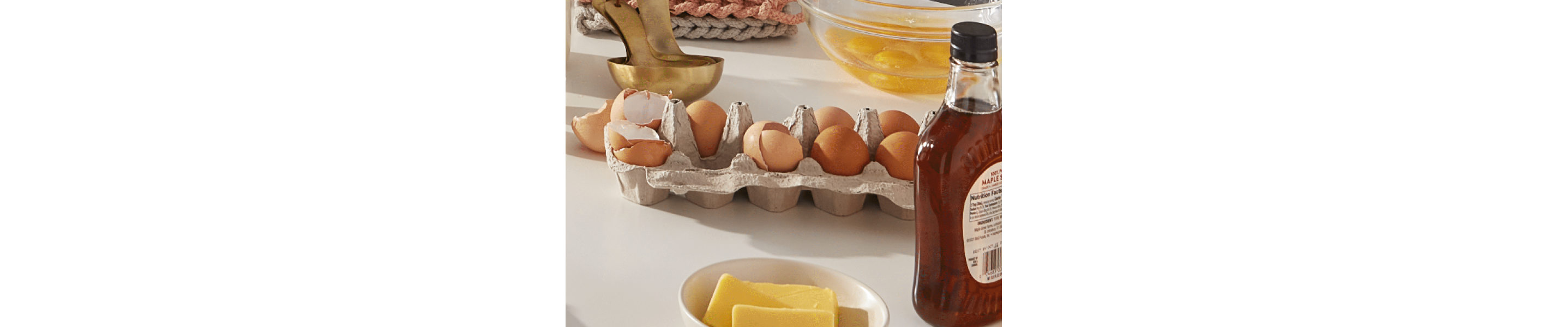 A carton of eggs, some of which are cracked