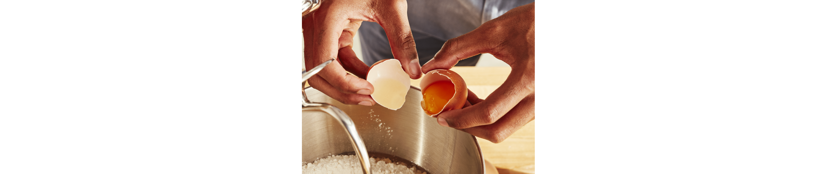 Hands cracking an egg