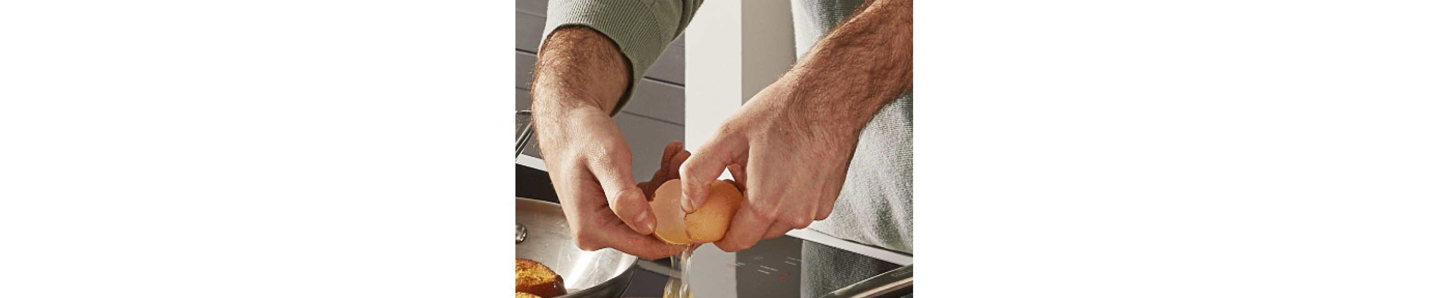 Hands cracking an egg