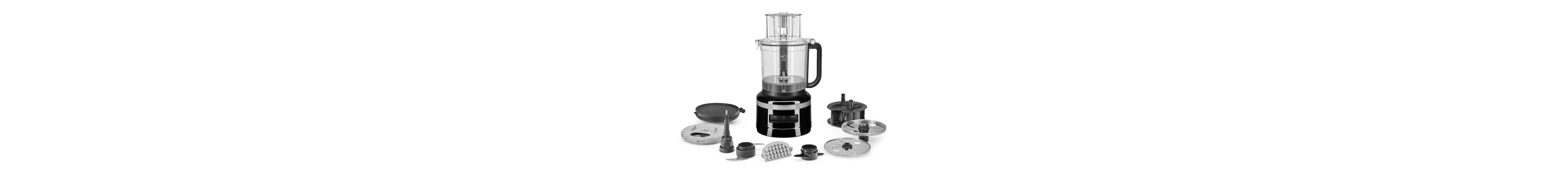 Black food processor surrounded by various food processor accessories