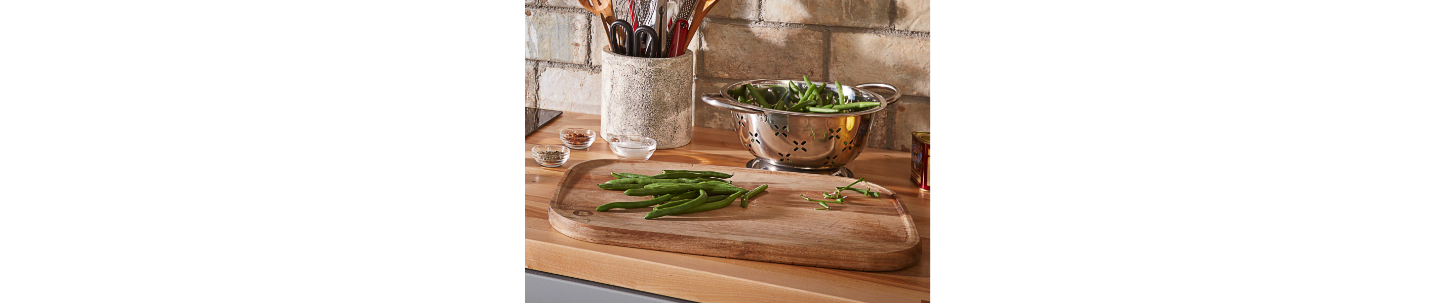 Fresh green beans on a wooden cutting board