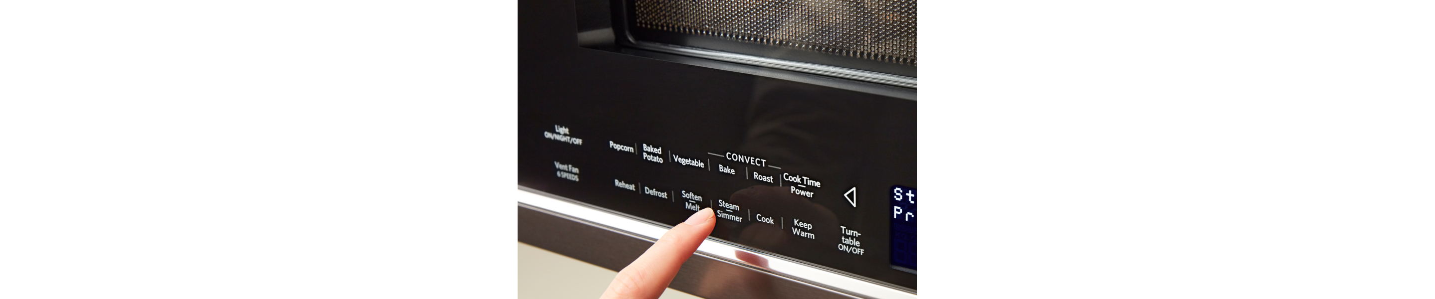 Person selecting Steam/Simmer on a KitchenAid® microwave