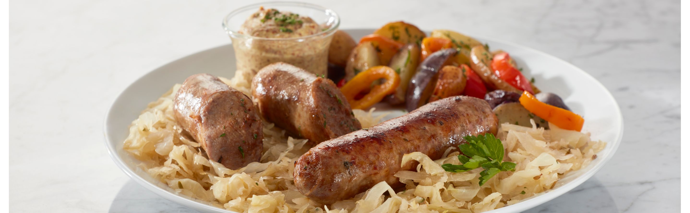 Sausages on a plate of pasta