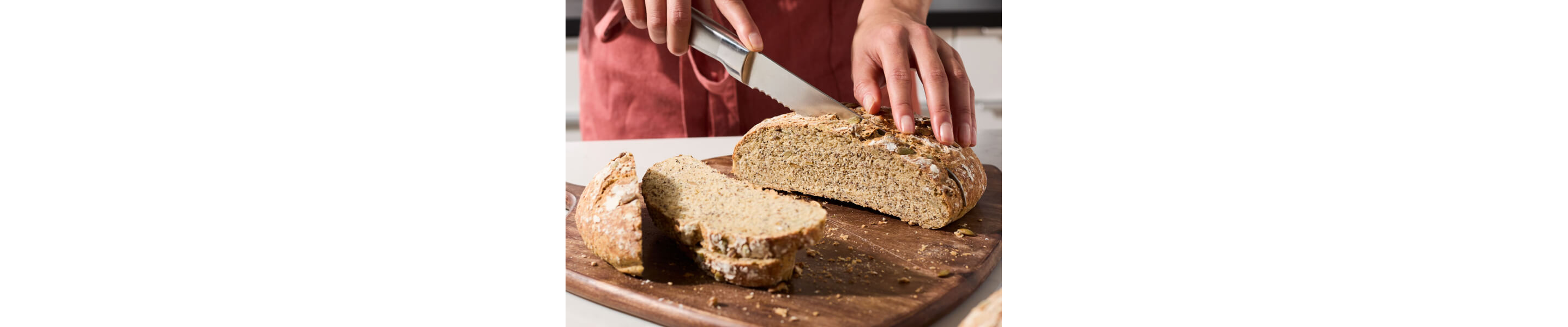 Person slicing bread
