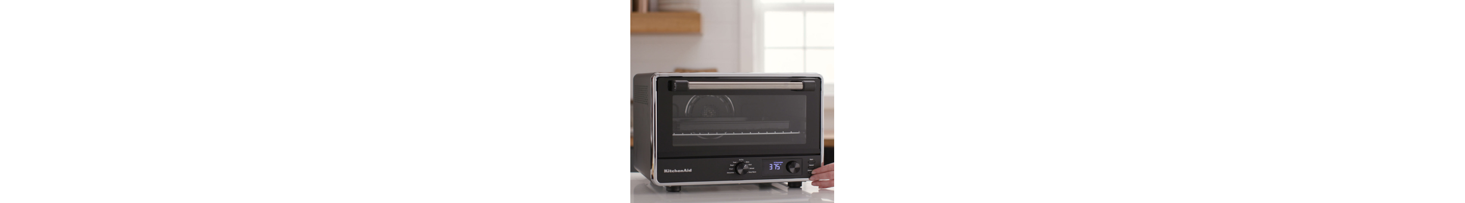 A black KitchenAid® countertop oven with a closed door