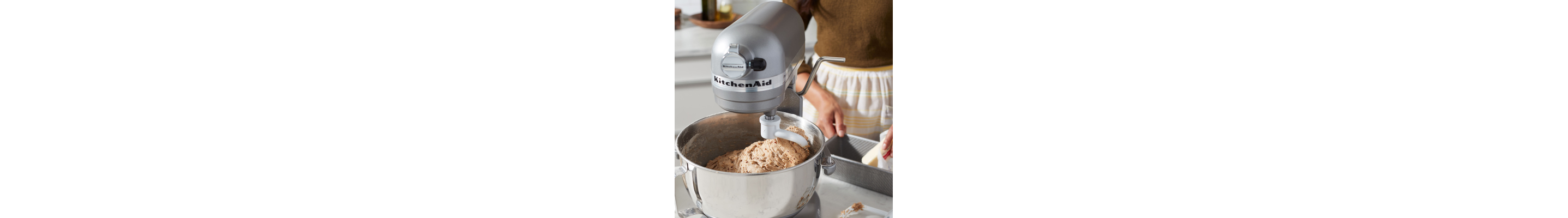 Dough being mixed in a stand mixer bowl.