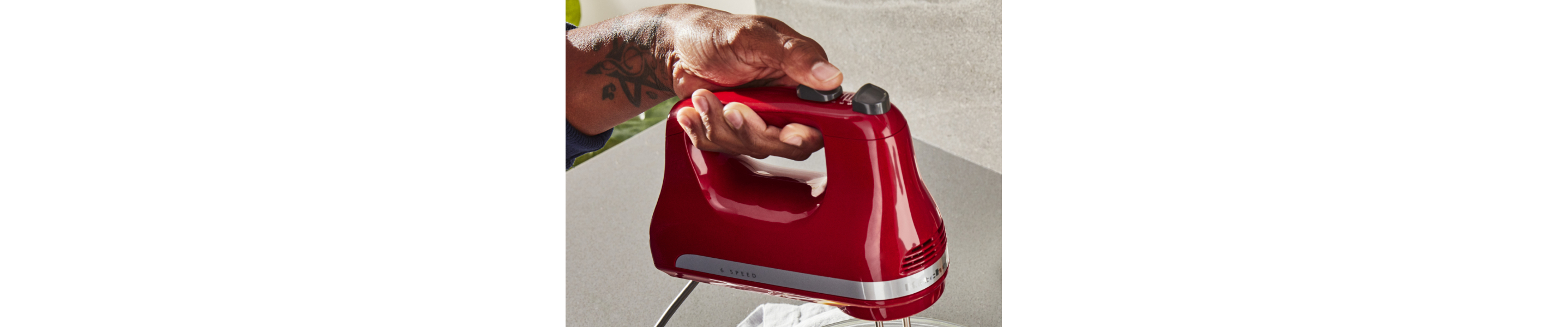 Person pressing button on KitchenAid® hand mixer
