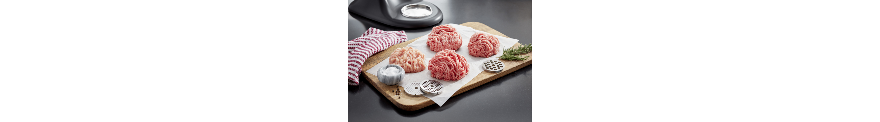 Piles of ground meat on a wooden cutting board