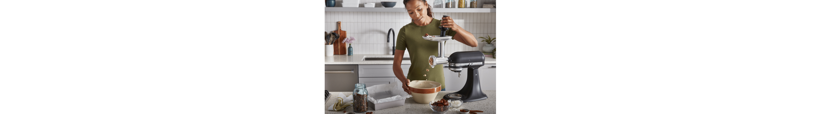 Person grinding meat with a KitchenAid brand Metal Food Grinder attachment