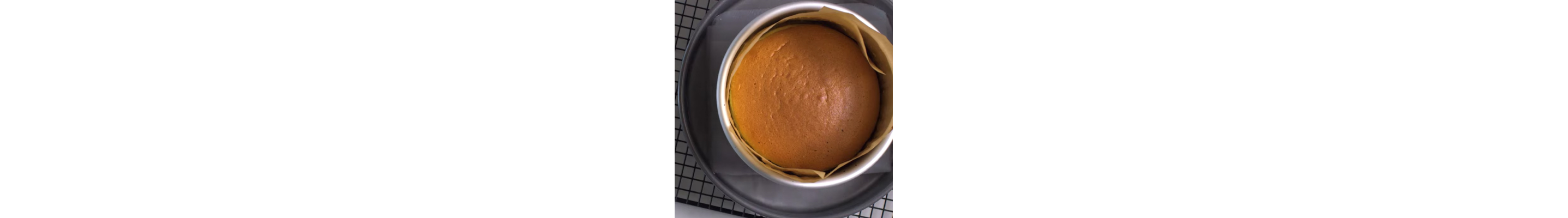 Cake in pan with parchment paper.