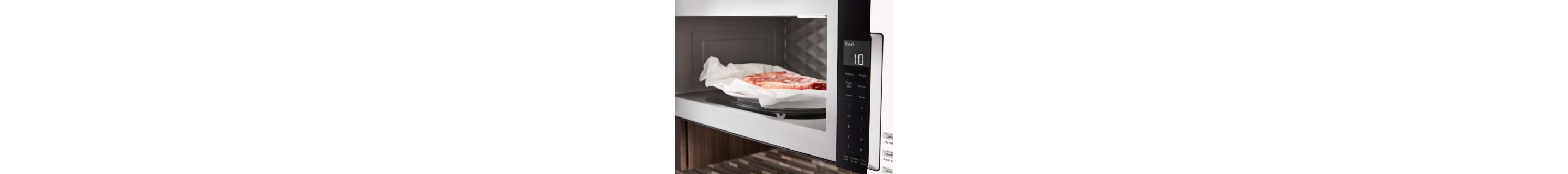 Meat on a plate inside microwave