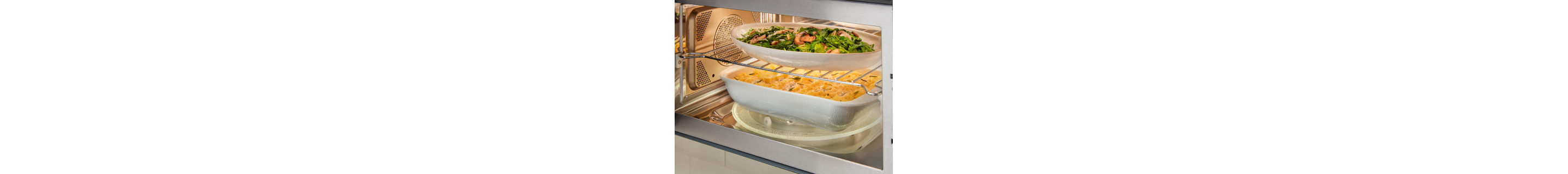 Meal on top rack and another meal on the turntable inside a microwave