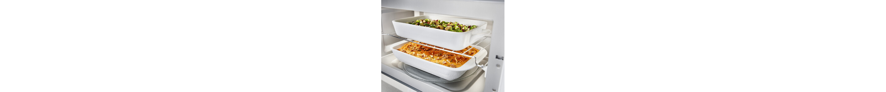 Two baking dishes inside a microwave