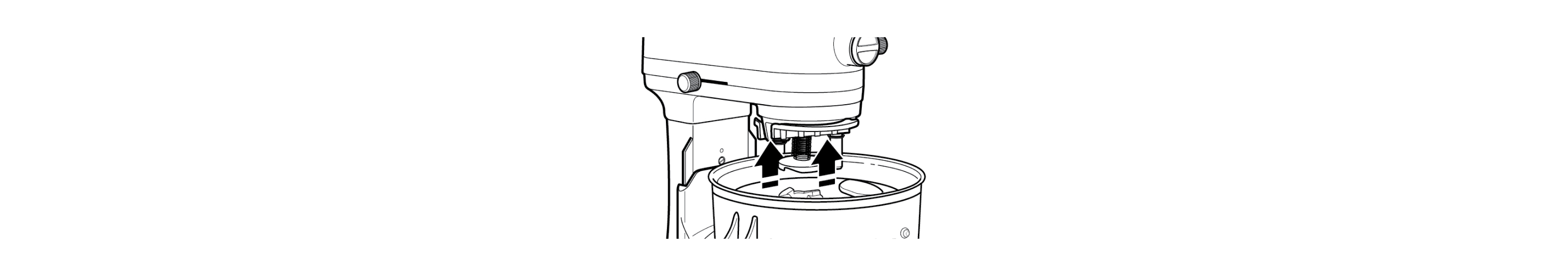 Drive assembly correctly positioned on stand mixer with arrows indicating push