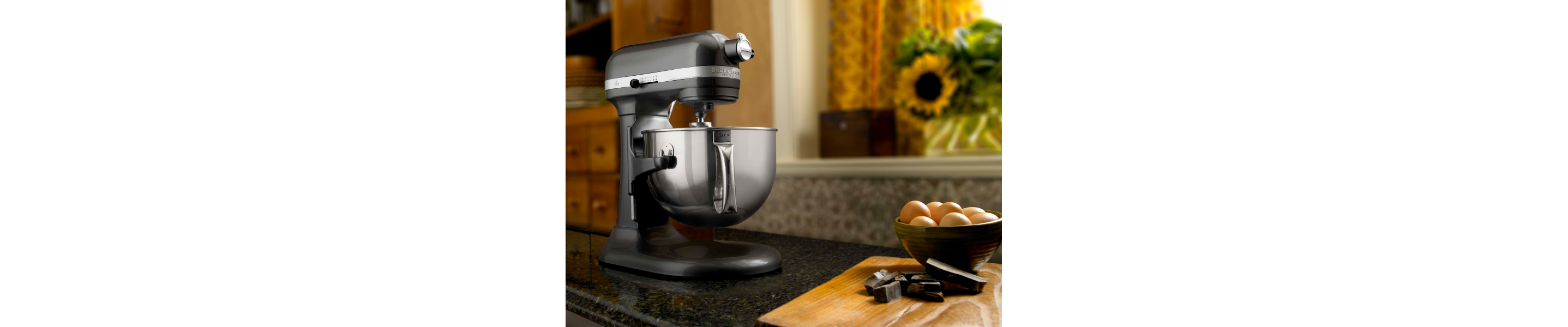 KitchenAid® stand mixer next to a bowl of fresh eggs.