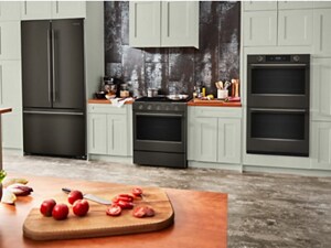 Suite of Black Ore KitchenAid® Appliances in light sage green cabinetry