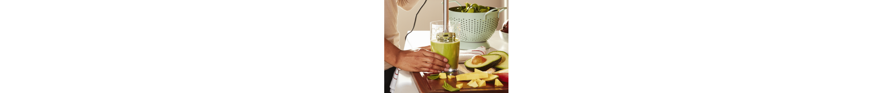 Blending an avocado smoothie in a drinking glass