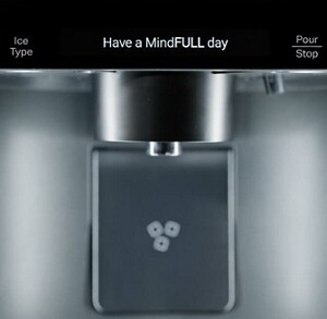 A close-up of the water dispenser of a MindFULLness Fridge