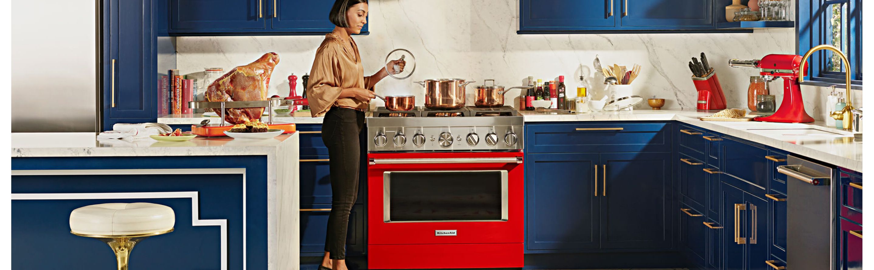 Red KitchenAid® range set in blue, modern kitchen
