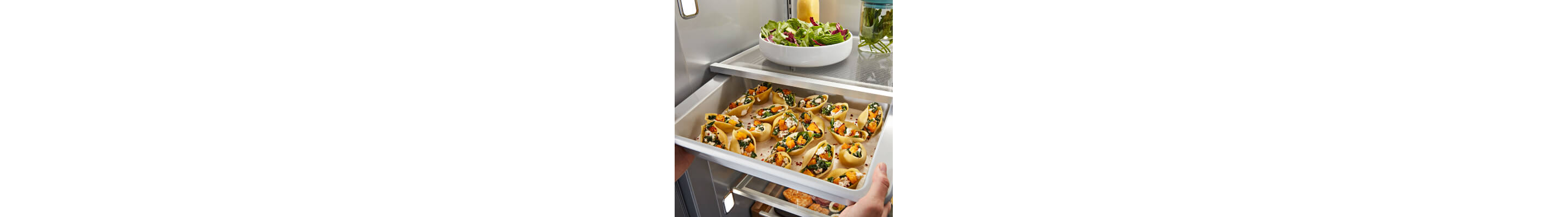 A refrigerator tray filled with a sheet of fresh food 