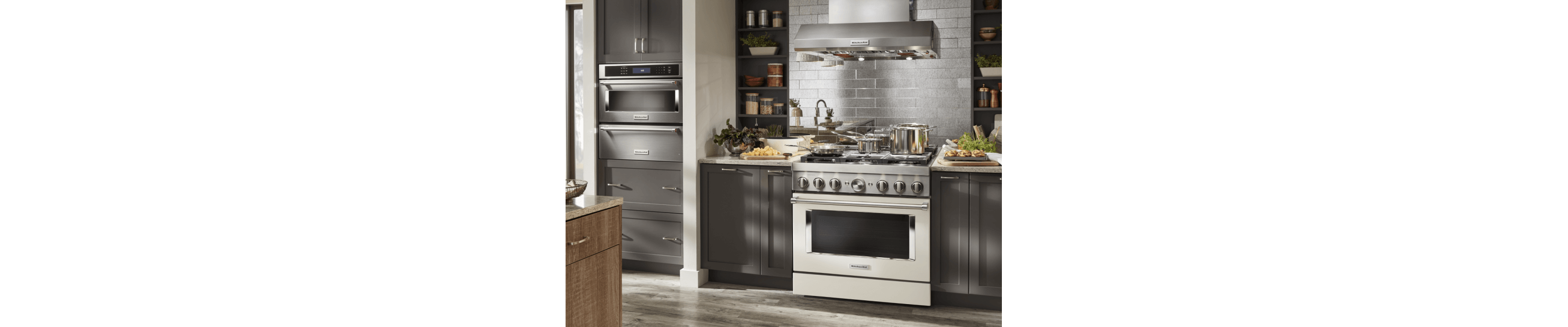 Kitchen with dark gray cabinets and stainless commercial-style range 