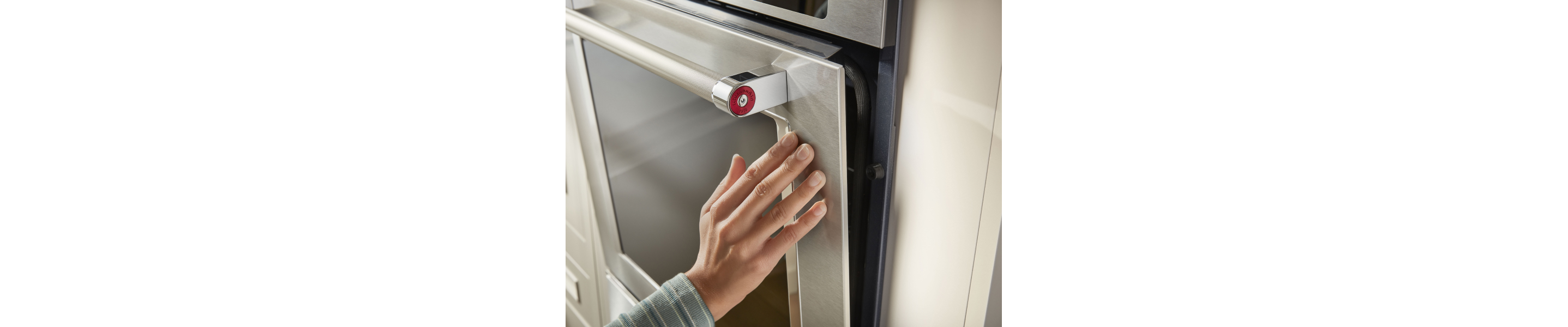 Person closing a KitchenAid® wall oven