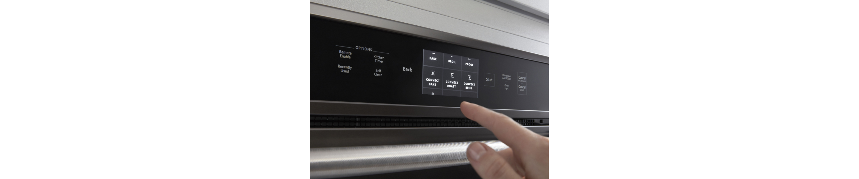 Person selecting a bake setting on a KitchenAid® wall oven