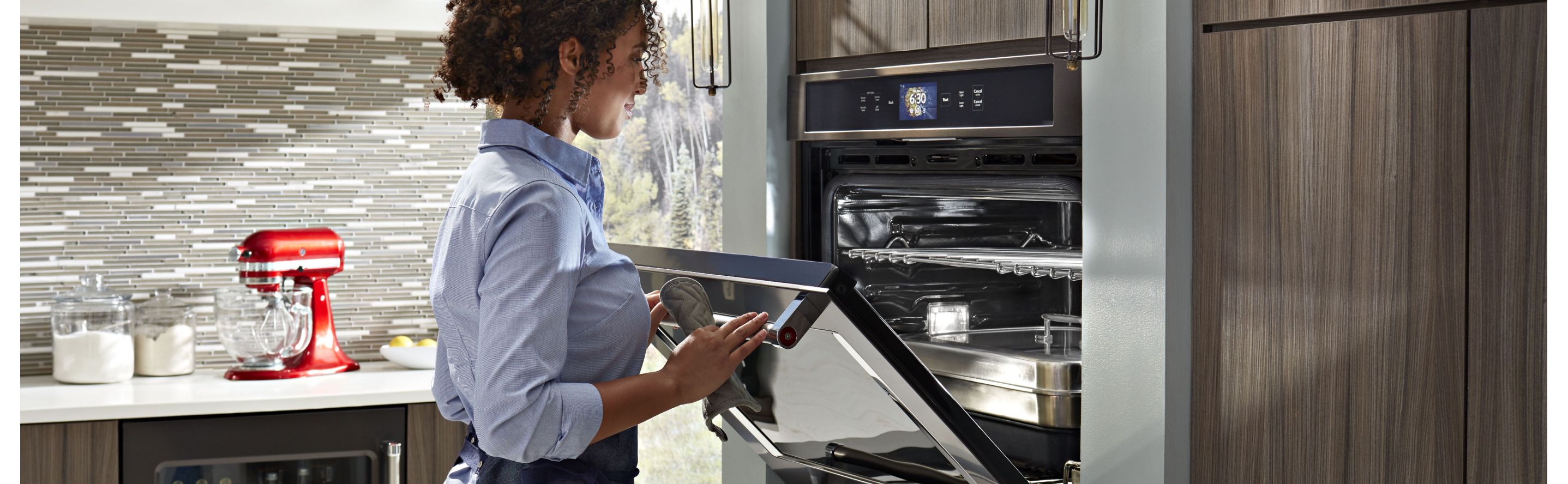 Person opening a KitchenAid® wall oven