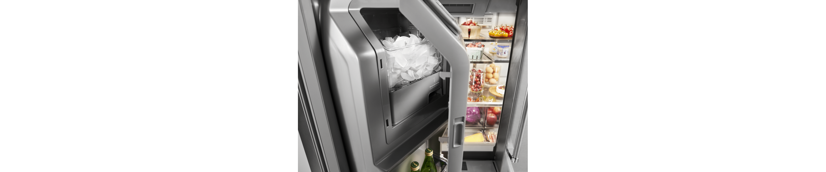 An ice dispenser in a KitchenAid® refrigerator.