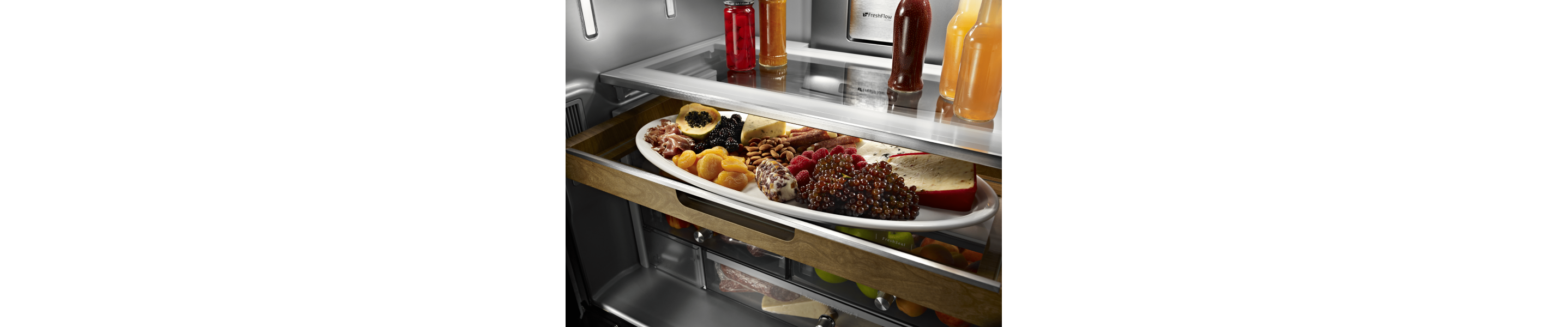 A sliding storage tray with fruits and cheeses.