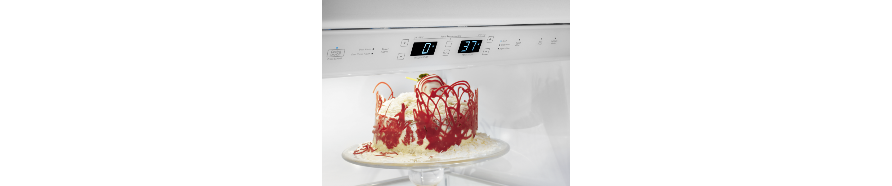 A red and white cake in a refrigerator.
