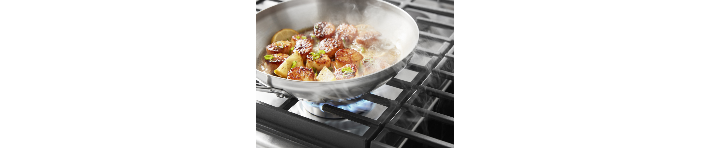 Scallops cooking on a gas cooktop