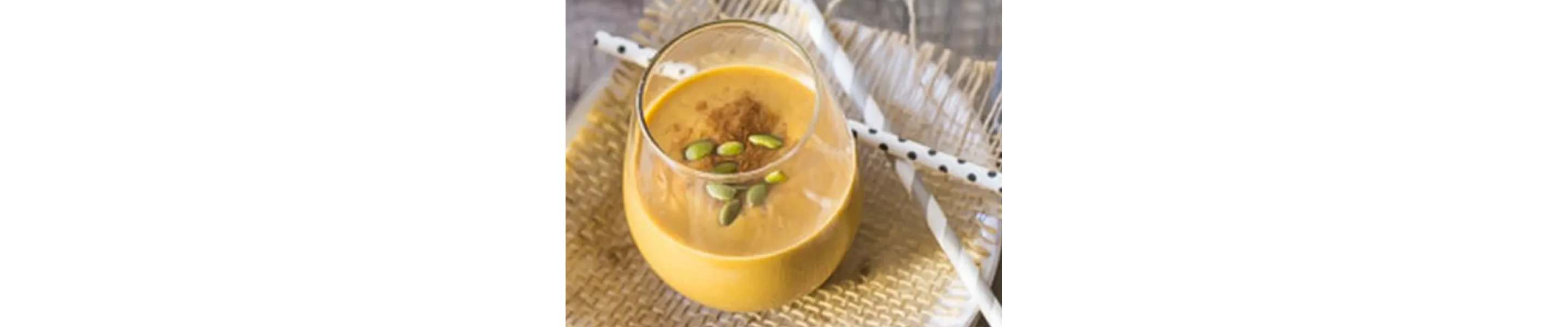 Pumpkin spice latte smoothie garnished with pumpkin seeds