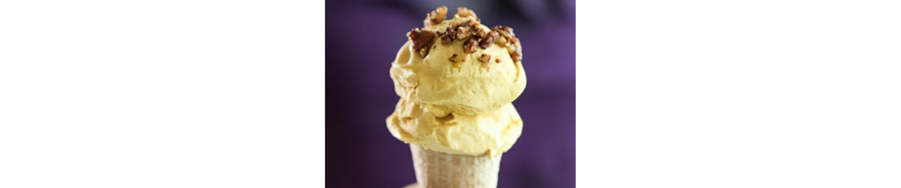 Scoops of pumpkin pie ice cream on a cone