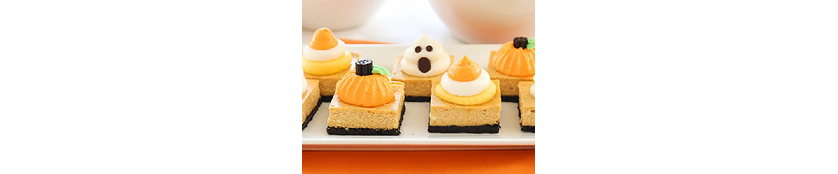 Pumpkin cheesecake bars with ghost, pumpkin and candy corn pipe work