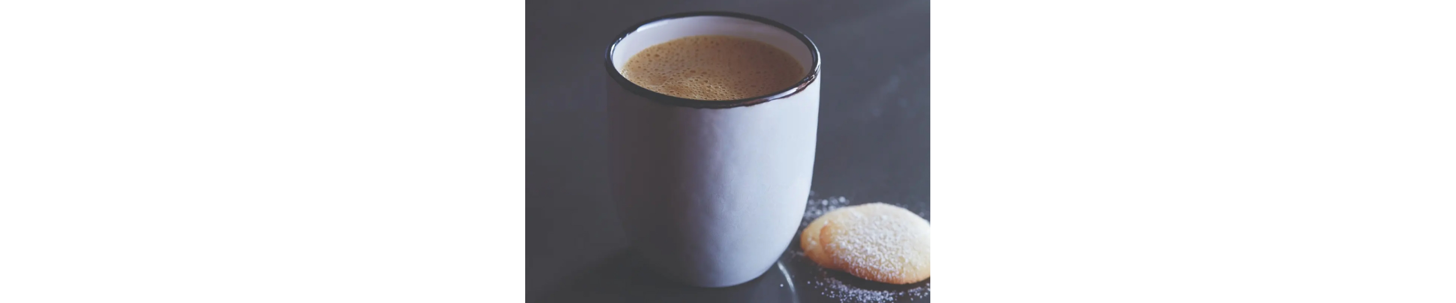 Mug of pumpkin spice latte next to wafer cookies