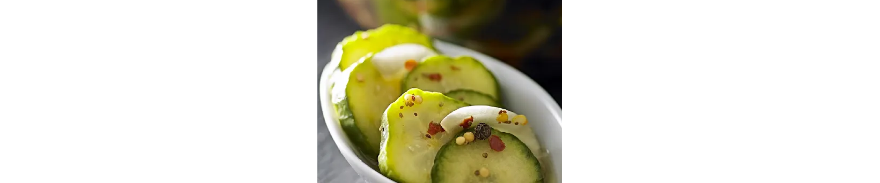 Spiced pickle chips in a white bowl